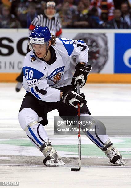 Juhamatti Aaltonen of Finland runs with the puck during the IIHF World Championship group A match between Germany and Finland at Lanxess Arena on May...