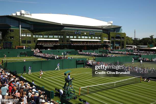 Mona Barthel of Germany plays against Yanina Wickmayer of Belgium during their Ladies' Singles first round match on day one of the Wimbledon Lawn...