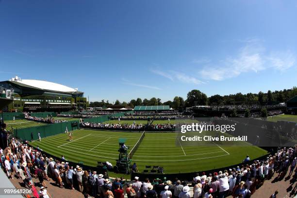 Mona Barthel of Germany plays against Yanina Wickmayer of Belgium during their Ladies' Singles first round match on day one of the Wimbledon Lawn...