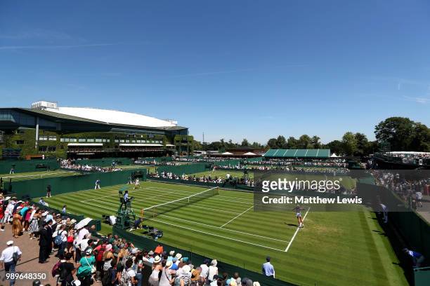 Mona Barthel of Germany plays against Yanina Wickmayer of Belgium during their Ladies' Singles first round match on day one of the Wimbledon Lawn...