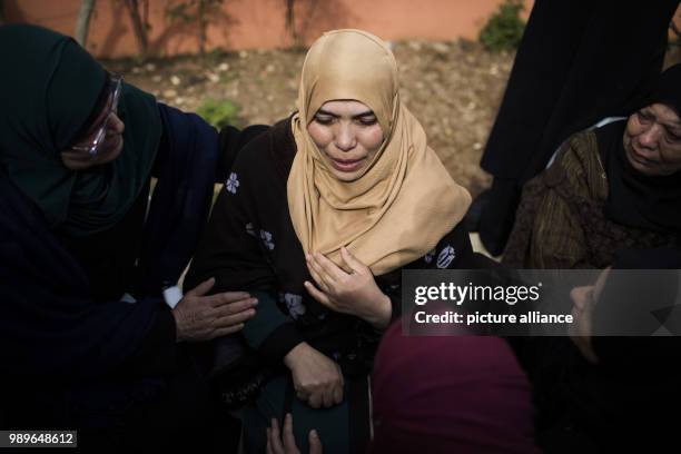 Relative of 17-year-old Palestinian Musab Tamimi cries during his funeral, after he was shot dead a day earlier in clashes with Israeli soldiers, in...