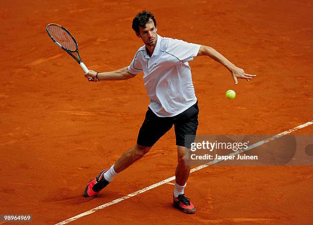 Philipp Petzschner of Germany plays a ball to Fabio Fognini of Italy in their first round match during the Mutua Madrilena Madrid Open tennis...