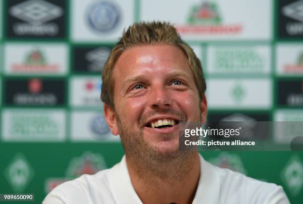 July 2018, Germany, Bremen: Head Coach of Werder Bremen, Florian Kohfeldt, sitting at a press conference about the start of training for the...