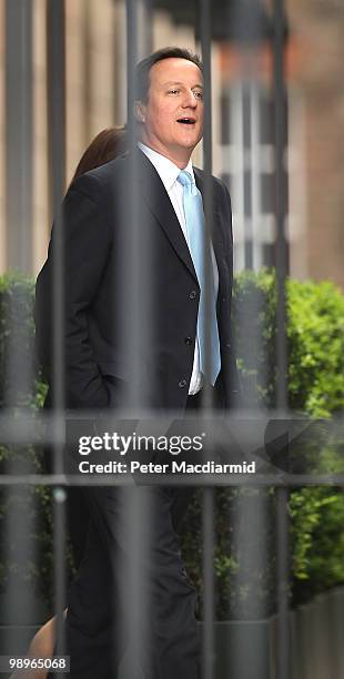 Conservative Party leader David Cameron walks through a fenced off area of Portcullis House at Parliament on May 11, 2010 in London, England. British...