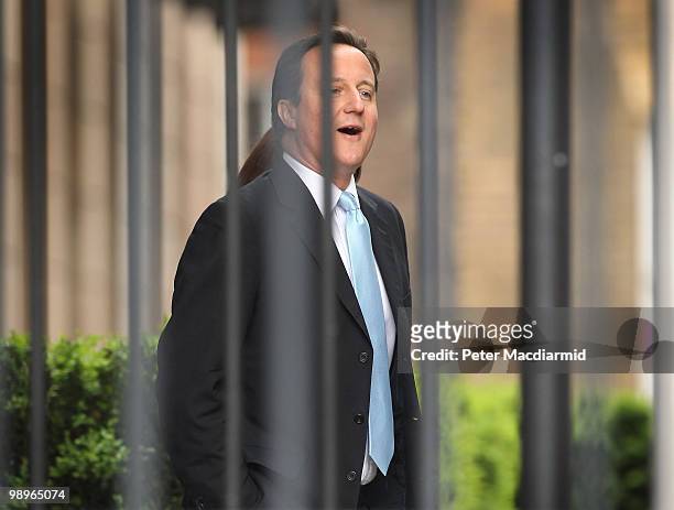 Conservative Party leader David Cameron walks through a fenced off area of Portcullis House at Parliament on May 11, 2010 in London, England. British...
