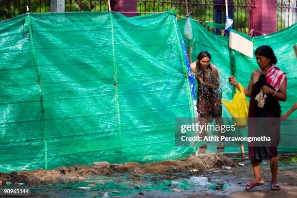 Anti-government 'Red Shirt' protesters shower inside their encampment on May 11, 2010 in Bangkok, Thailand.The Red Shirts have accepted a...