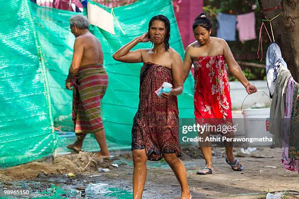 Anti-government 'Red Shirt' protesters shower inside their encampment on May 11, 2010 in Bangkok, Thailand.The Red Shirts have accepted a...