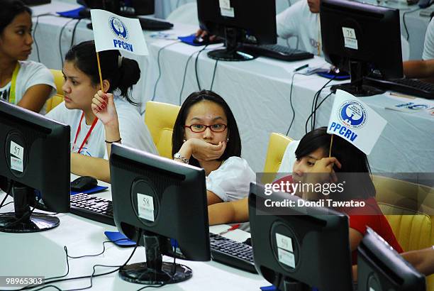 Youth volunteers wave a flag upon completion of tabulated results on May 11, 2010 in Manila Phillipines . The country went to the polls yesterday to...