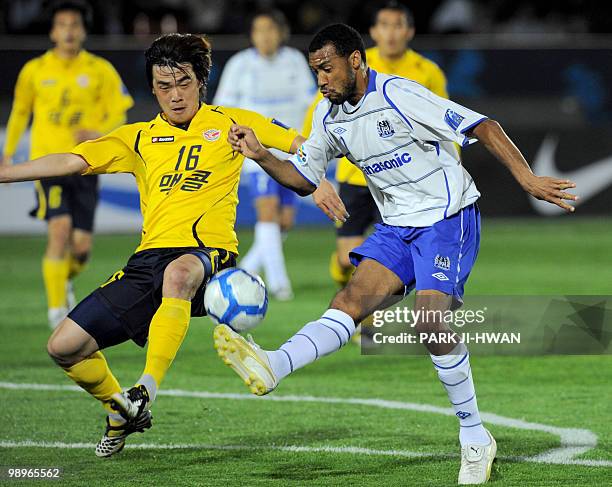 Lucas of Japan's Gamba Osaka and Kim Sung-Hwan of South Korea's Seongnam Ilhwa FC fight for the ball during the AFC Champions League round 16 match...