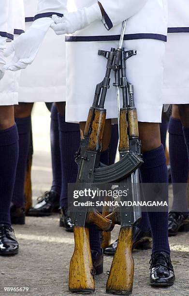 Sri Lankan Navy volunteer female sailor adjusts her glove prior to their passing out ceremony at Welisara Navy base in Colombo, 29 November 2006. Sri...