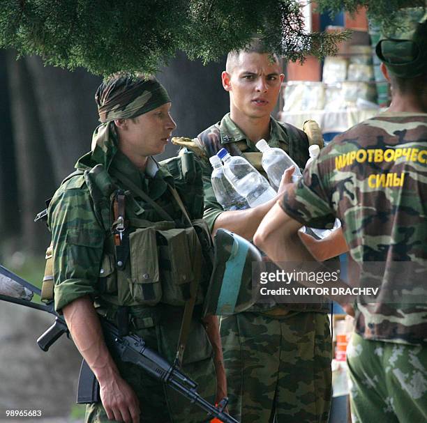 Russian troops buy food and water from local vendors in the Georgian breakaway region of Abkhazia on the outskirts of the town Gali on August 12,...