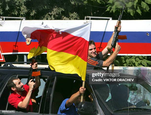 Residents of Tskhinvali fire kalashnikov machine guns in the air as they celebrate the recognition of South Ossetian independence by the Russian...