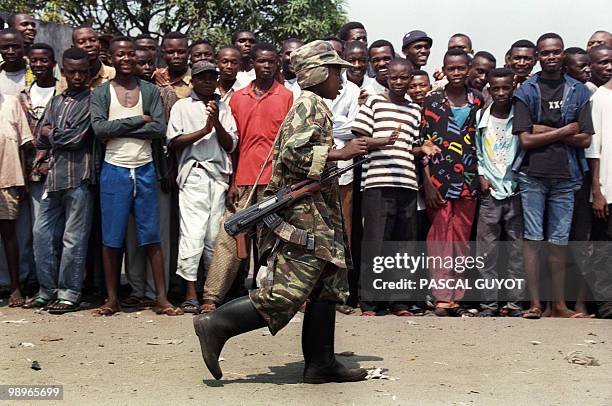 Child soldier from the Laurent-Desire Kabila's rebel troops of the Alliance of Democratic Forces for the Liberation of Congo-Zaire, patrols in...