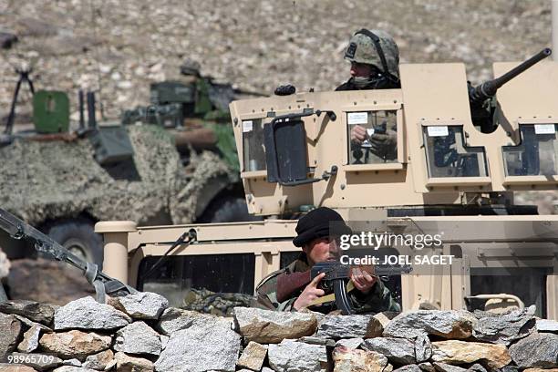 Soldier of ANA with a kalashnikov, US marine in a hummer and French VAB are pictured during the CIMIC operation on February 16, 2009 in Dawlatkhel,...