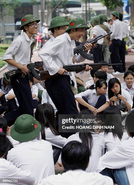 High-school students hold Soviet-made Kalashnikov semi-automatic riffles during a military training session at a park in downtown Hanoi, 06 September...