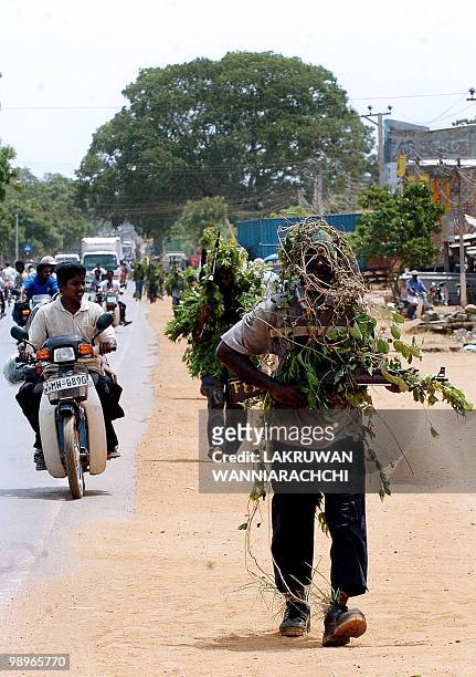 Members of the Liberation Tigers of Tamil Eelam home guard walk down the main street of rebel-held Kilinochchi town while on manoeuvers, about 250...
