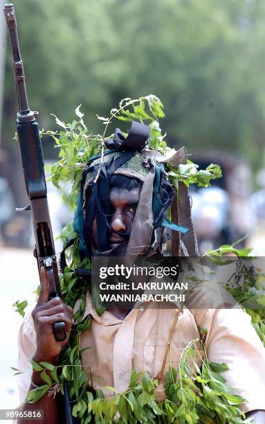 Member of the Liberation Tigers of Tamil Eelam home guard walks down the main street of the rebel-held Kilinochchi town while on manoeuvers, about...