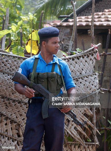 Sri Lankan Navy soldier stands guard on the coast at Bopitiya, near the town of Negombo, 17 June 2006 after two frogmen tried to commit suicide by...