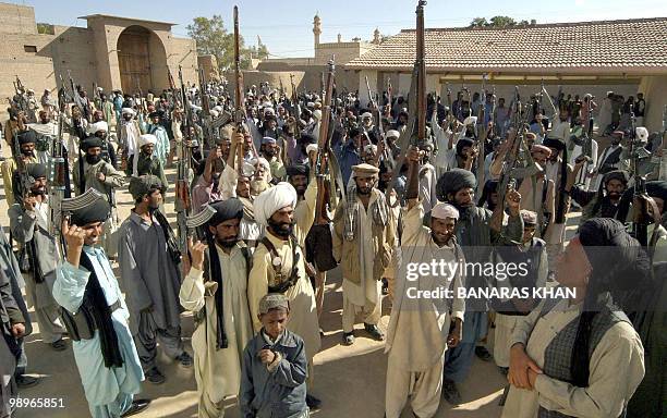 Pakistani Baluch tribesmen raise their weapons as they gather for a Jirga at Dera Bugti, in southwest Baluchistan province,16 January 2005. Millions...