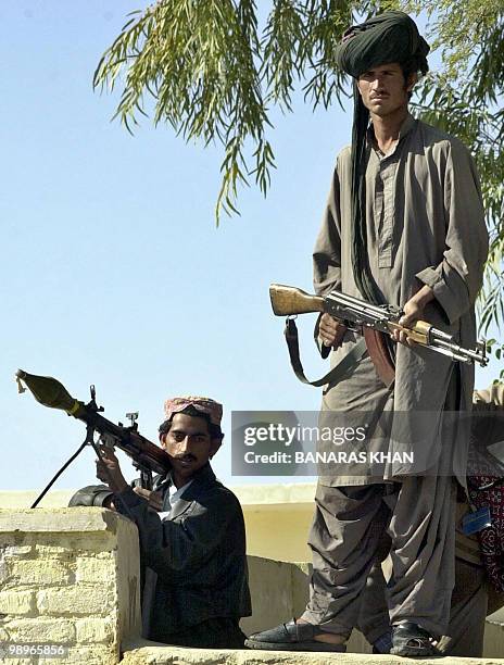 Pakistani Baluch tribesmen stand guard over a Jirga at Dera Bugti, in southwest Baluchistan province,16 January 2005. Millions of Pakistani...