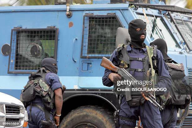 Ivorian hooded gendarme officers escort the van carrying French alleged gang leader Youssouf Fofana on his way to board a Paris-bound plane at...
