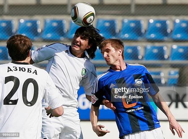 Vladimir Kuzmichyov of FC Saturn Moscow Oblast battles for the ball with Serghei Covalciuc of FC Tom Tomsk during the Russian Football League...