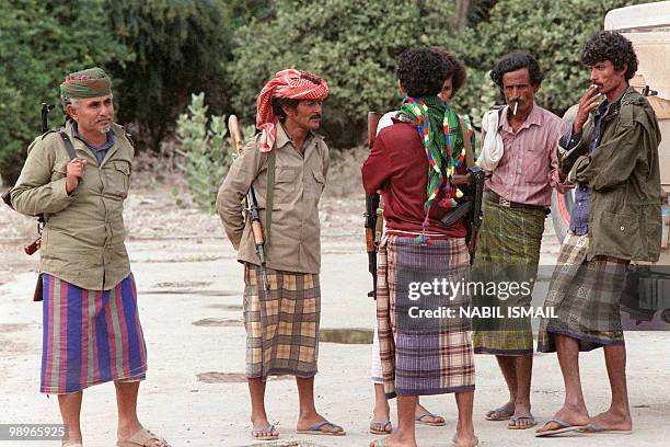 Militiamen, partisan of Yemen Socialist Party senior leader Abdul Fattah Ismail, smoke, on February 02 near a checkpoint in Aden. On January 13 a...