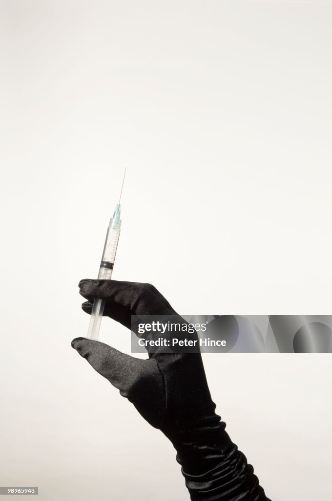 Gloved Hand with Hypodermic syringe