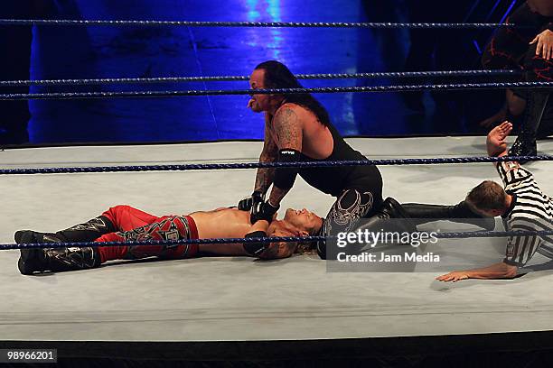 Wrestling fighters, Edge and Undertaker fight during the WWE Smackdown Wrestling at Arenal Monterrey on May 9, 2010 in Monterrey, Mexico.