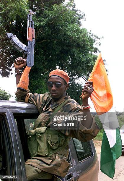 Rebel fighters patrol the streets of the central Ivorian city of Bouake, one of two towns held by mutineers, 26 September 2002. As the evacuation of...