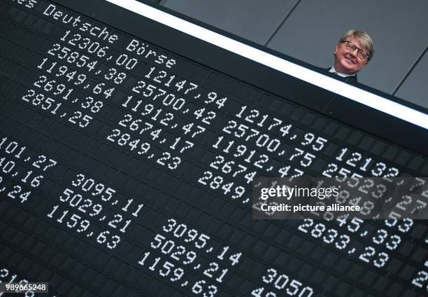 July 2018, Germany, Frankfurt: Chairman of the Deutsche Boerse AG, Theodor Weimer , Frank Mella, standing over a display board with the indexes of...