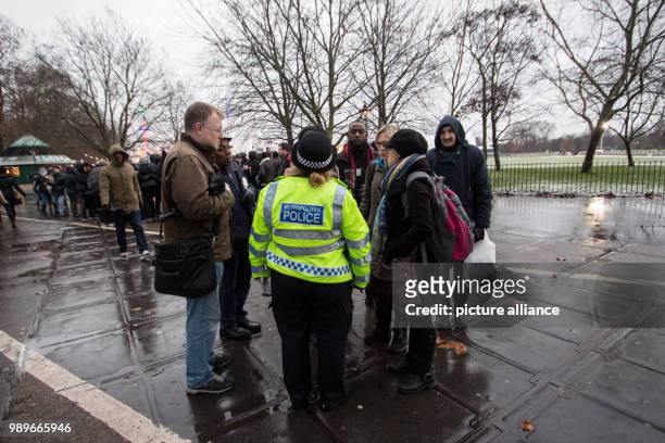Police officer settles a dispute between spectators of the Speakers' Corner at Hyde Park in London, Britain, 10 December 2017. Violent offences are...