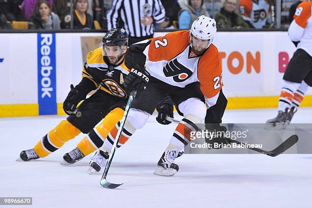 Ville Leino of the Philadelphia Flyers skates with the puck against Patrice Bergeron of the Boston Bruins in Game Five of the Eastern Conference...