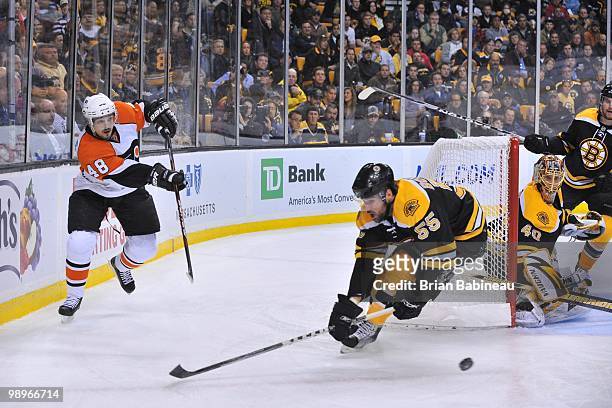 Danny Briere of the Philadelphia Flyers passes the puck against Johnny Boychuk of the Boston Bruins in Game Five of the Eastern Conference Semifinals...