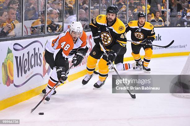 Danny Briere of the Philadelphia Flyers skates with the puck against Mark Stuart of the Boston Bruins in Game Five of the Eastern Conference...