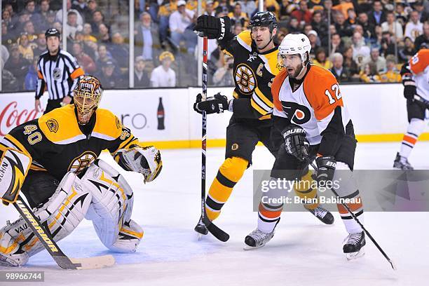 Tuukka Rask and Zdeno Chara of the Boston Bruins watch the play against Mike Richards of the Philadelphia Flyers in Game Five of the Eastern...