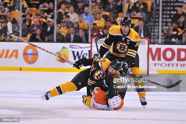 Trent Whitfield of the Boston Bruins falls on top of Ville Leino of the Philadelphia Flyers in Game Five of the Eastern Conference Semifinals during...