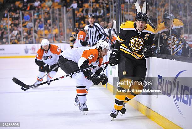 Zdeno Chara of the Boston Bruins gets hit by Braydon Coburn of the Philadelphia Flyers in Game Five of the Eastern Conference Semifinals during the...