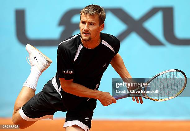 Marco Chiudinelli of Switzerland serves against Marcos Baghdatis of Cyprus in their first round match during the Mutua Madrilena Madrid Open tennis...