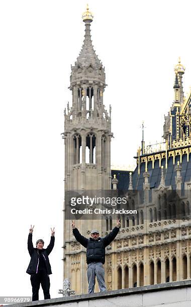 Protestors signal from the roof of St Margarets Chapel opposite the Houses of Parliament in Westminster on May 11, 2010 in London, England. British...
