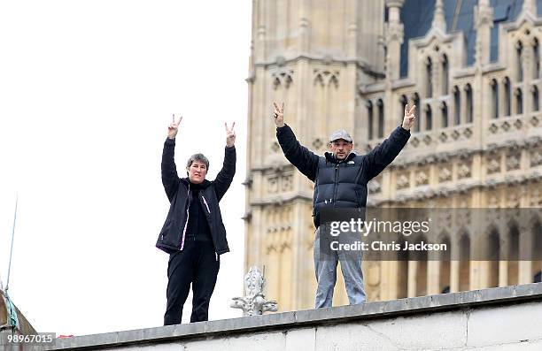 Protestors signal from the roof of St Margarets Chapel opposite the Houses of Parliament in Westminster on May 11, 2010 in London, England. British...