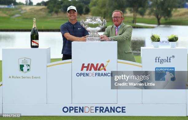 Alex Noren of Sweden poses with European Ryder Cup Director Richard Hills after the final round of the HNA Open de France at Le Golf National on July...