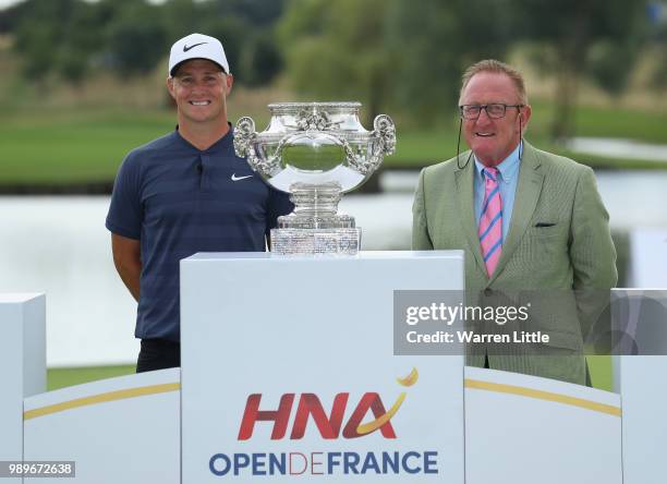 Alex Noren of Sweden poses with European Ryder Cup Director Richard Hills after the final round of the HNA Open de France at Le Golf National on July...