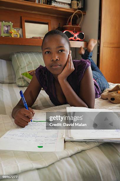 teenage girl (16-17) doing homework, cape town, western cape province, south africa - malan stock-fotos und bilder