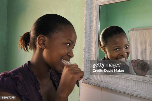 teenage girl (16-17) brushing teeth, cape town, western cape province, south africa - western cape province stock-fotos und bilder