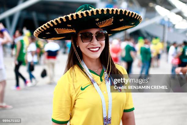 Brazil fan sporting a typical Mexican hat poses before the Russia 2018 World Cup round of 16 football match between Brazil and Mexico at the Samara...