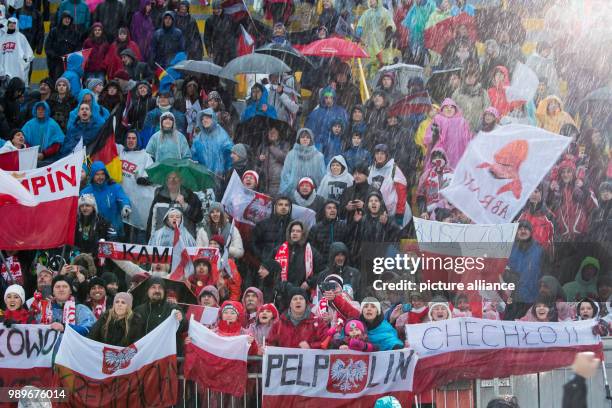 Polish fans celebrate the victory of ski jumper Kamil Stoch in the Four Hills Tournament in Innsbruck, Austria, 4 January 2018. Photo: Daniel...