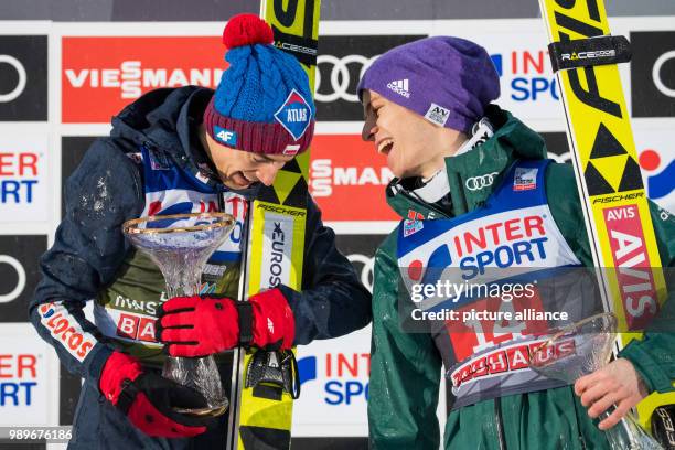 Polish ski jumper Kamil Stoch and German ski jumper Andreas Wellinger stand on the podium after the second round of the Four Hills Tournament in...