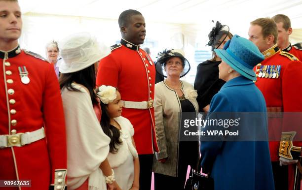 Queen Elizabeth II meets Guardsman Gavin Francis from the Grenadier Guards after presenting the 1st Battalion, the Grenadier Guards with new...