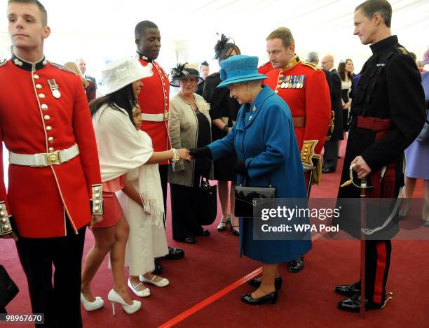 Queen Elizabeth II meets Kerry Sund, a guest of the Grenadier Guards, after presenting the regiment with their new colours on May 11, 2010 in London,...